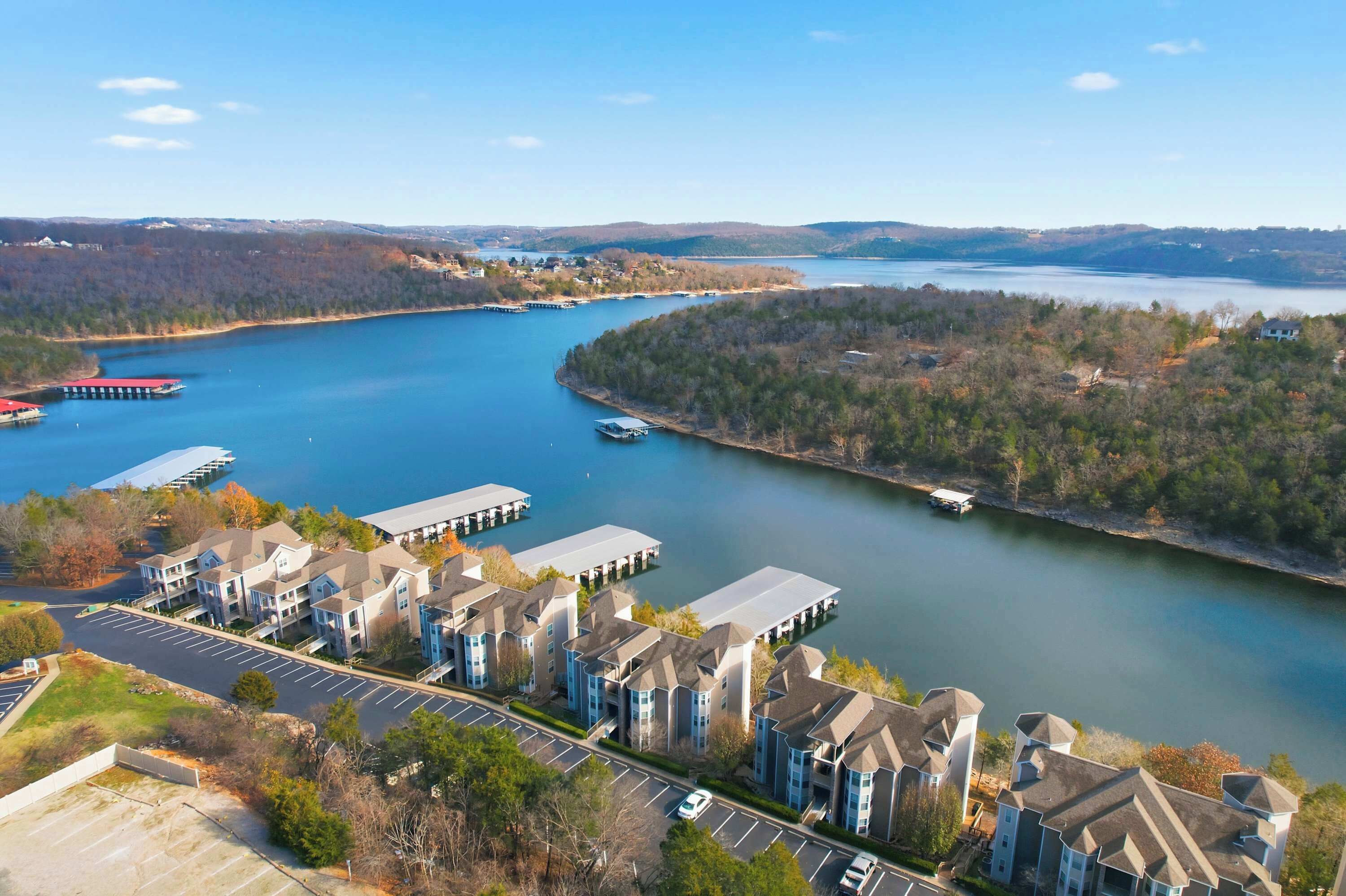 A residential area with a marina, docked boats, and a parking lot.