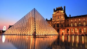 The Louvre Pyramid with its reflection in the water, surrounded by classical architecture. - ICONIC LANDMARKS THE LOUVRE MUSEUM ,TUILERIES GARDEN ARE JUST A STROLL AWAY (Paris)