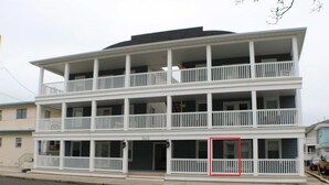 A multi-story building with balconies, a visible address number, and a street view. - Peaceful 2-bedroom condo in Wildwood Crest, close to beach (Wildwood)