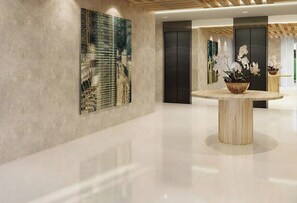 A modern lobby with a polished floor, a wooden table with a vase of flowers, and a large abstract painting on the wall. - S FLATS MOTA BEIRA MAR (Fortaleza)