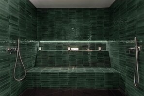A modern bathroom with green tiles, a built-in bench, and a shower area. - Villa Pomona - Five Bedroom Villa, Sleeps 10 (Frigiliana)