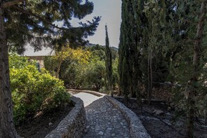 A stone pathway leading through a garden with various trees and shrubs. - Villa Pomona - Five Bedroom Villa, Sleeps 10 (Frigiliana)