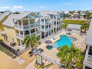 A multi-story hotel with a pool area, including lounge chairs and a sign reading "Casa la playa". - Dauphin Beach House (Port Aransas)