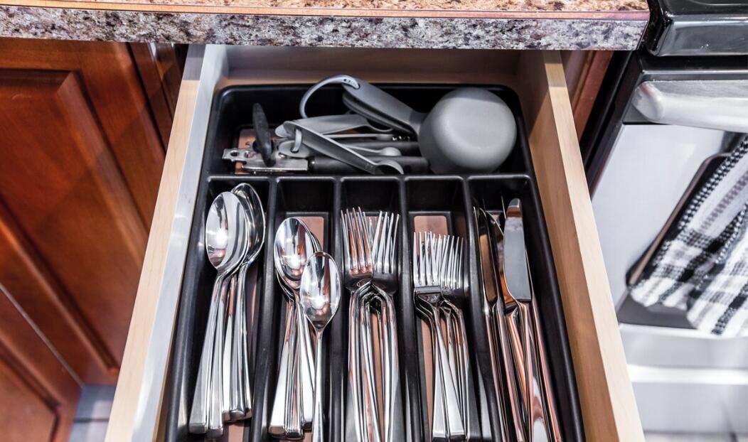 A kitchen drawer with utensils neatly organized.