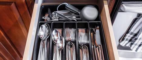 A kitchen drawer with utensils neatly organized.