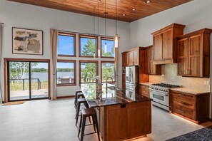Fridge, microwave, oven, stovetop - Escape to Lakeview Paradise, a luxury 4-bed, 3-bath lakefront retreat in Tripoli, WI. Each bedroom has a king bed, and the 2,560 sq. ft. home features high-end finishes, cozy comforts, and stunning lake views from a private 24-ft deck or hot tub. (Tripoli)