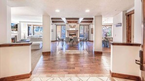 A spacious living area with a fireplace, dining table, and modern furniture.