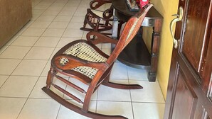 A dining area with wooden furniture, a dining table, chairs, and a sofa. - Beautiful bedroom shared house in charming León awaits you (León)
