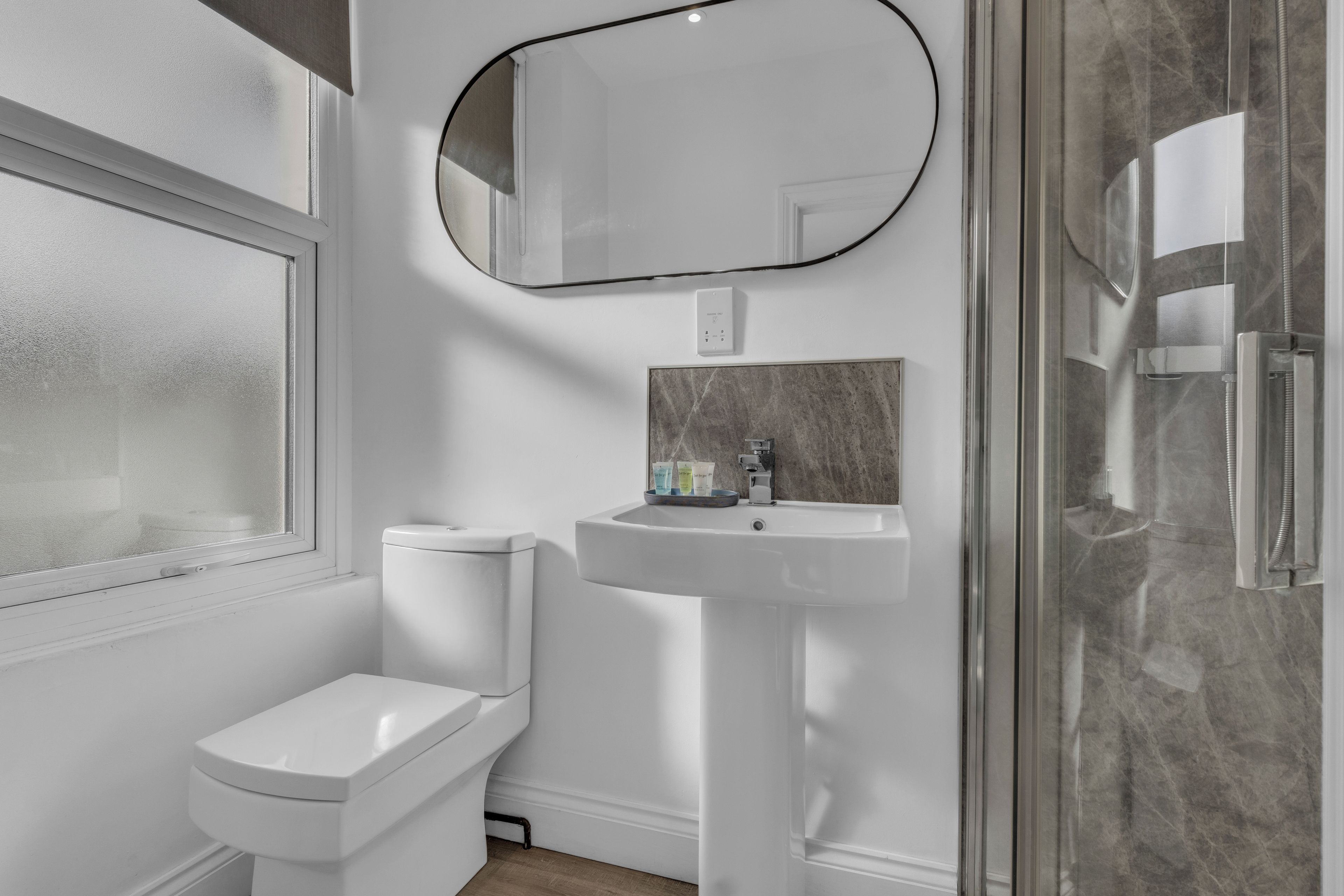 Bright modern bathroom with walk-in shower and natural light