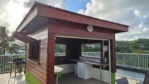 A small wooden structure with a kitchen area, including a sink and a window. - Villa with private swimming pool, quiet and friendly stay (Le Vauclin)