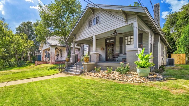 A two-story house with a porch, a chimney, and a well-maintained lawn. - Emma’s Cottage on Madison Avenue (Montgomery)