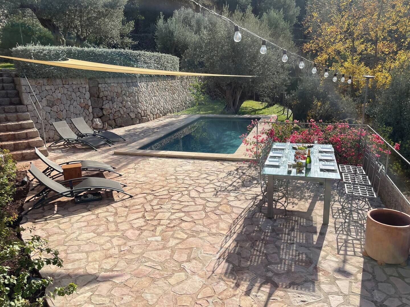 Private pool with large terraced area, sun loungers and casual eating