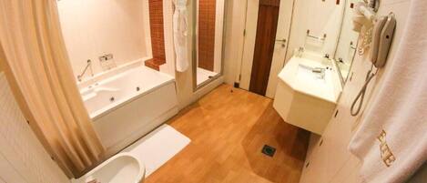 A bathroom with a bathtub, a sink, and a toilet.