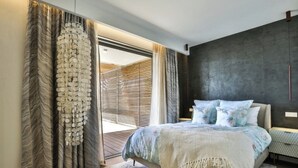 A bedroom with a bed, curtains, a window, and a dark wall. - Le 120m2 - luxury, swimming pool, terrace and garage (Nice)