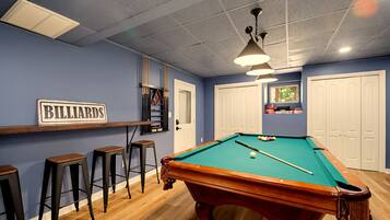 {Pool Table} Rack them up in the game room, where the pool table keeps the competition going long after dinner.