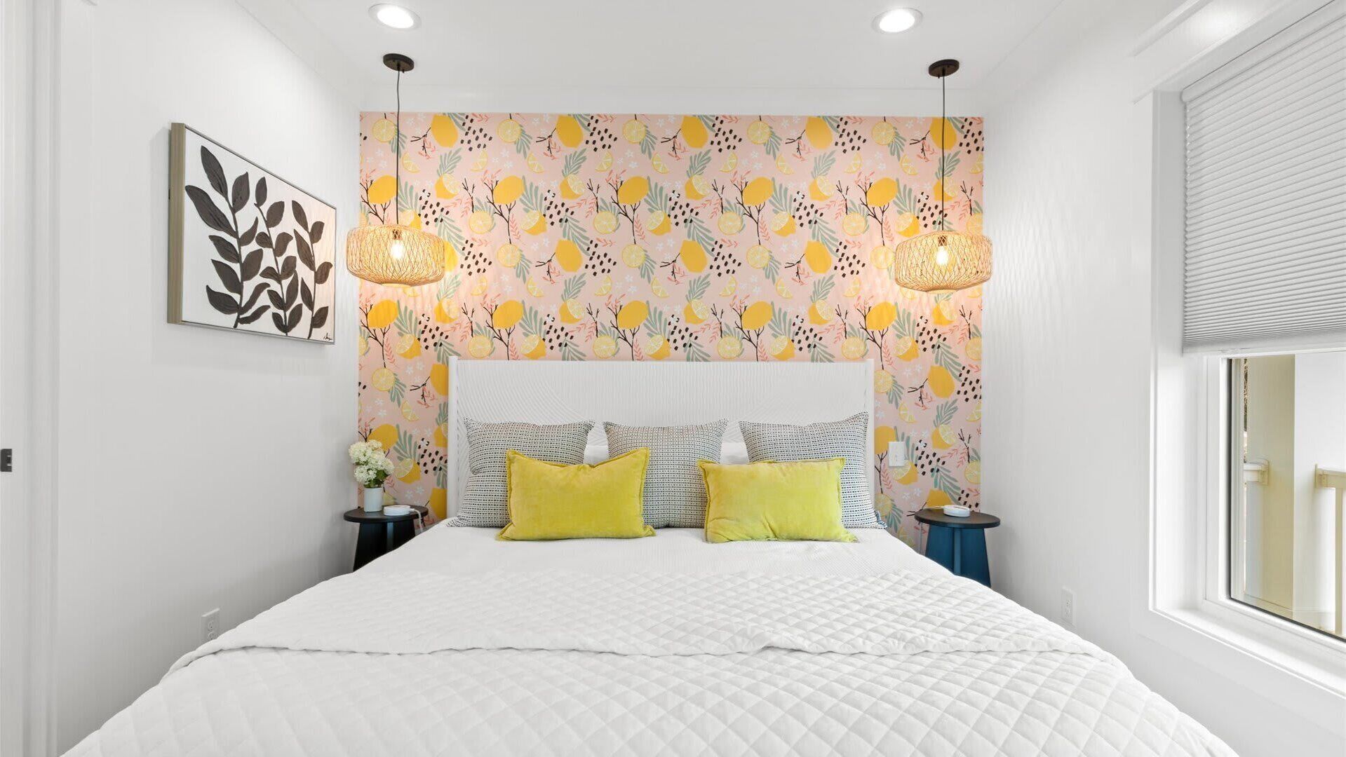 Une chambre à coucher moderne avec un grand lit, deux lampes de chevet et un papier peint à motifs.