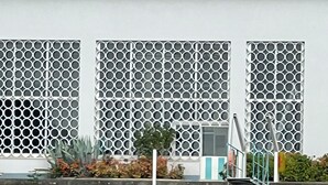 A building with a large sign reading "Riva" and a modern architectural design with a metal facade and patterned windows. - An ancient fresco above the gaze, the history around and the charm of Sarnico. (Sarnico)