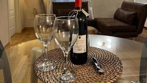 A dining area with a table set for two, a bottle of wine, and two wine glasses. - An ancient fresco above the gaze, the history around and the charm of Sarnico. (Sarnico)