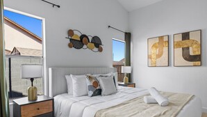 A neatly arranged bedroom with a bed, bedside tables, and artwork on the walls. - Summer Deal! Pool Home! Fast WiFi! Relocating! (Phoenix)