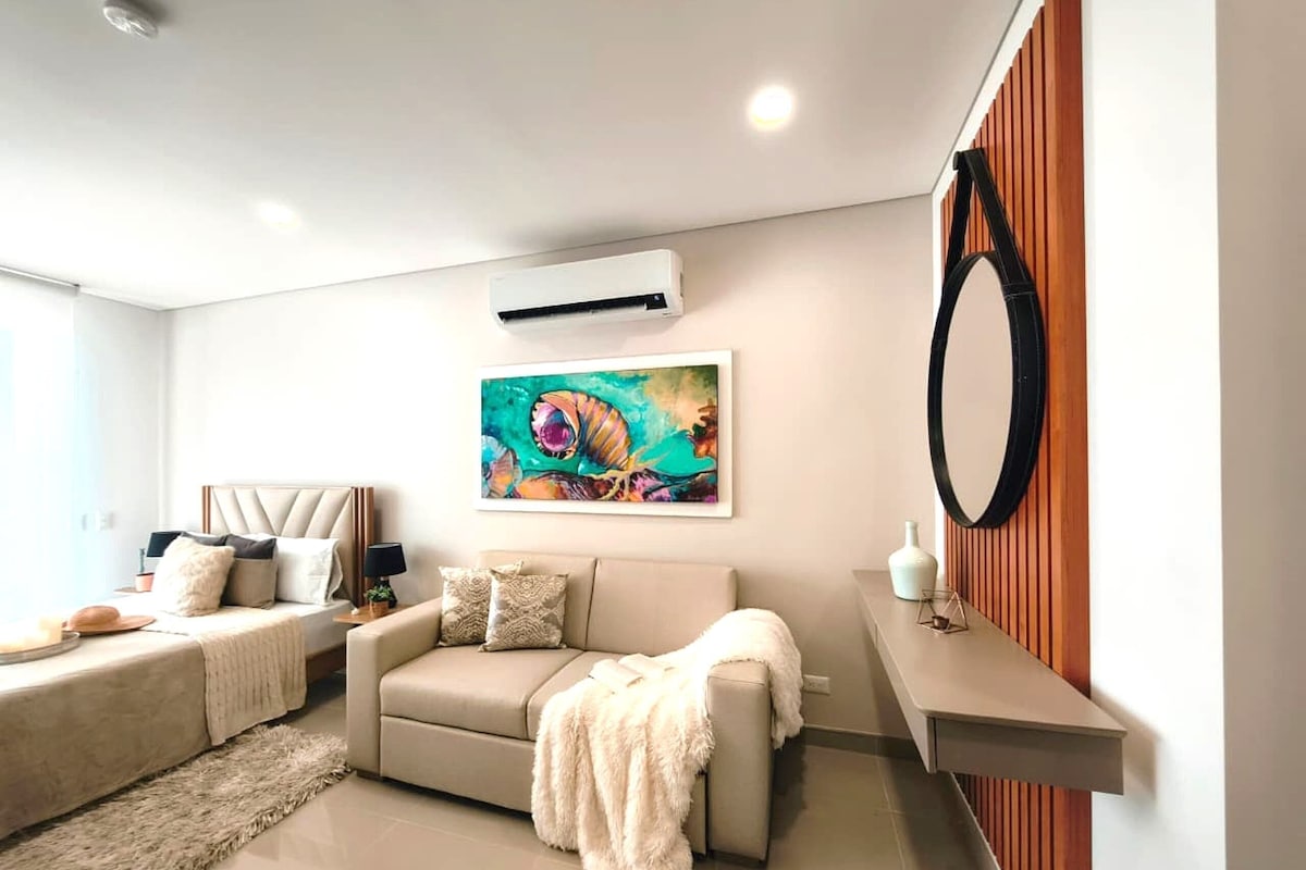 A modern living room with a sofa, a coffee table, and a painting on the wall.