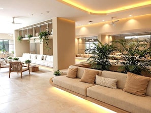 A modern living room with a sofa, chairs, and a coffee table.