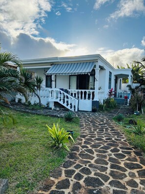 A white building with a stone pathway leading to a white staircase. - Comfortable Bungalow with Large Private Garden – Grand Gaube North of Mauritius (Grand Gaube)
