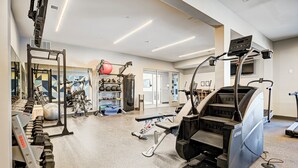 A gym with cardio equipment, weight machines, and free weights. - 1 King Bed/1Bth - Broad Ripple (Indianapolis)