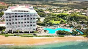 A large hotel with multiple floors and a swimming pool. - Hilton Vacation Club Kaanapali Beach Club (Lahaina)