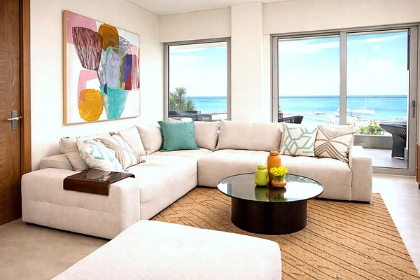 Comfortable living room with ocean views and 86` smart TV