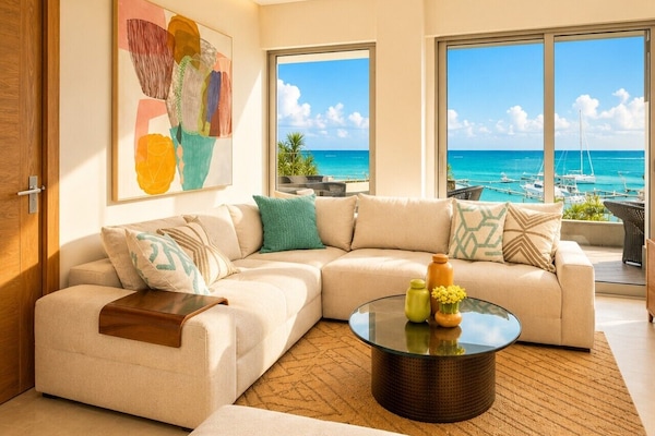 Comfortable living room with ocean views and 86` smart TV