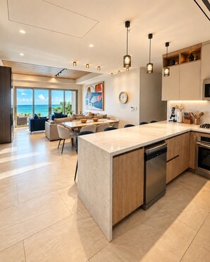 A modern kitchen with a large island, wooden cabinets, and a view to the outside.