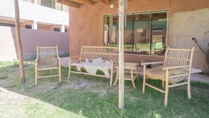 An outdoor seating area with wooden furniture and a thatched roof. - Cosy Room w/Bathroom in Prime Area (Písac)