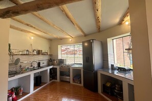 A kitchen with wooden beams, a large window, a refrigerator, and a stove. - Bright & Spacious Private Studio w/ Everything! (Písac)