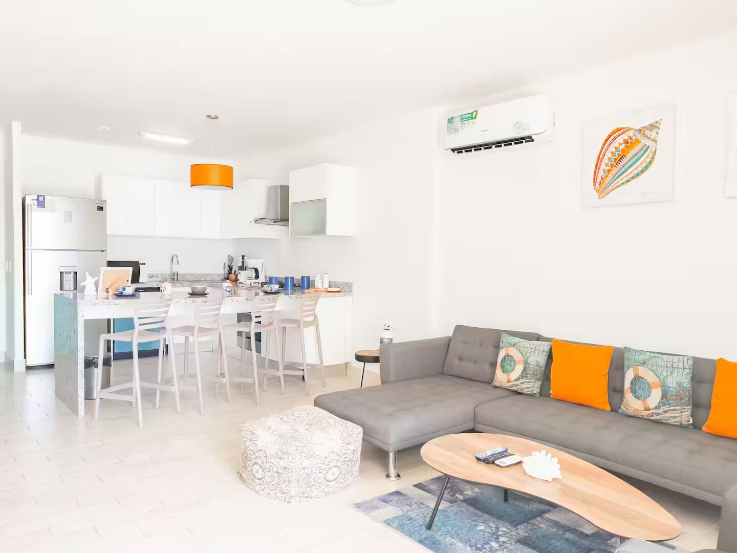A modern apartment with a kitchen, dining area, and living room.