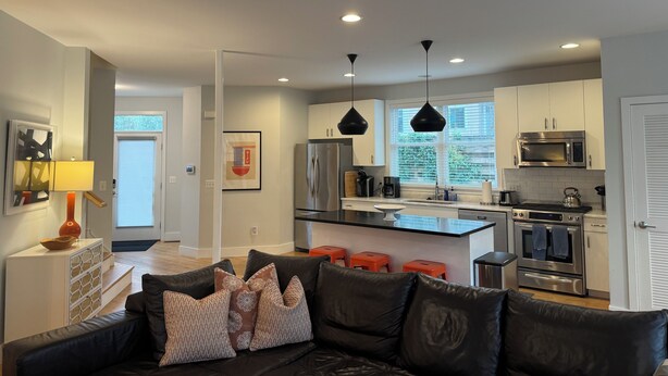 A modern kitchen with stainless steel appliances, a central island, and pendant lighting. - Adjacent to UVA Grounds, WALKABLE to Scott Stadium, Corner, Downtown (Charlottesville)