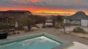 A swimming pool with a patio area, a house, and a hill with a structure on top. - Amazing Sea & Mountains Views
3 bed 4n half bathroom
Private 7m by 3mChukum pool (San Jose del cabo)