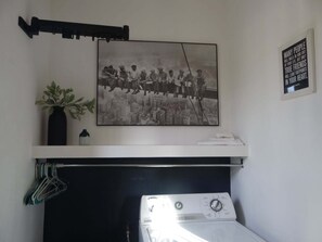 A laundry room with a washing machine, a hanging rack, and a framed picture on the wall. - Amazing Sea & Mountains Views
3 bed 4n half bathroom
Private 7m by 3mChukum pool (San Jose del cabo)