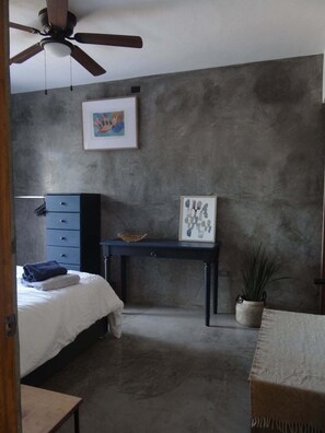 A bedroom with a bed, a desk, a ceiling fan, and two framed pictures on the wall. - Amazing Sea & Mountains Views
3 bed 4n half bathroom
Private 7m by 3mChukum pool (San Jose del cabo)