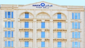 A multi-story building with a classical architectural style, featuring a central entrance with a pediment and columns. - Haven Plaza Hotel Riyadh  (Riyadh)