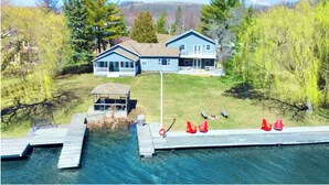 A lakeside property with a dock, two main buildings, and a gazebo. - Luxury Lake House - Hot Tub - Fire Pit - BBQ -Dock (Hasting)