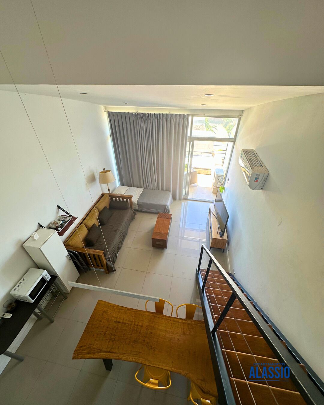 A modern apartment with a living area, a dining space, and a balcony.