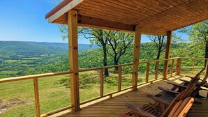 A wooden deck with a view of a green landscape. - Panoramic Views at Paul’s Point (Altamont)