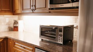 A kitchen with a built-in toaster oven, a microwave, and a dishwasher. - Cozy GEM-near Peterborough-Freshly decorated-Lakeview (Ennismore)