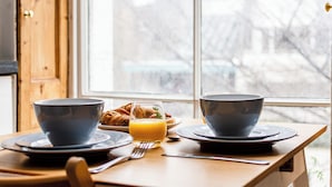 A breakfast table with two bowls, a glass of orange juice, a fork, and a knife. - The Russell Collection (London)