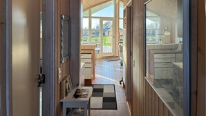 A narrow hallway with wooden walls and a view to a deck area. - Lovely home in Slagelse with WiFi (Slagelse)