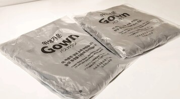 Two packages labeled 'Gown' with Korean text and a barcode.