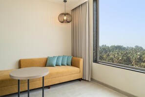 Deluxe Room, 1 King Bed | Living area | 55-inch Smart TV with satellite channels, Netflix, streaming services - Hilton Garden Inn Goa Calangute (Calangute)