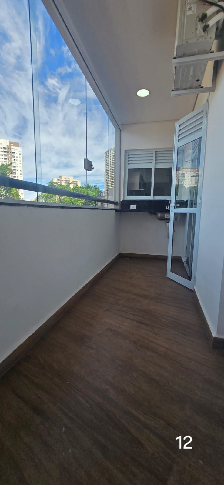Un balcón con vistas a edificios y un cielo nublado.