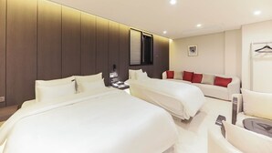 A modern hotel room with two beds, a sofa, and a small table. - HOTEL SIGNATURE GWANGJU (Gwangju)