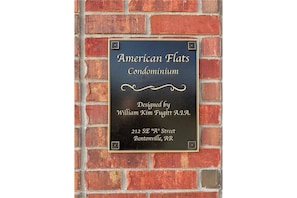 A plaque on a brick wall.